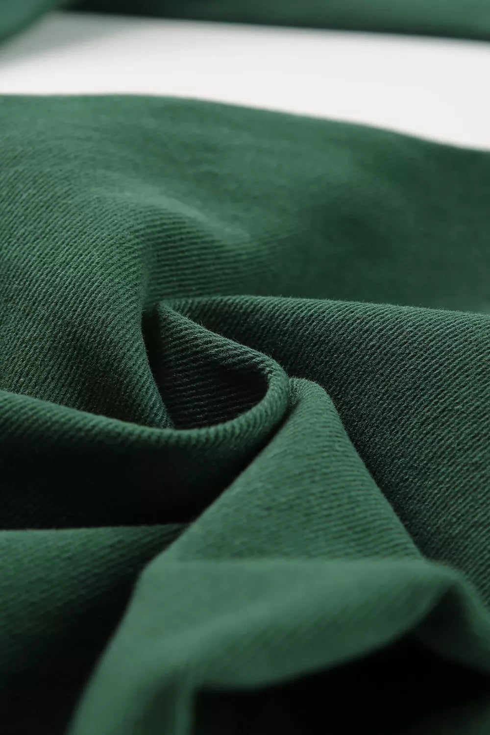 Green cotton jeans with crossed v-waist detail and straight leg cut.