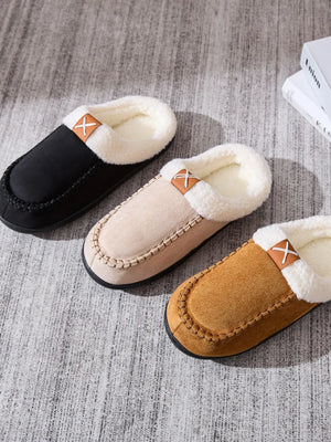 Suede shearling-lined moccasin slides in black, caramel, and khaki with cross detail.