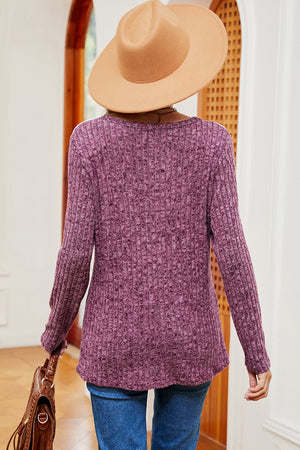 Lilac ribbed knit top with eyelet shoulder detail and long sleeves.