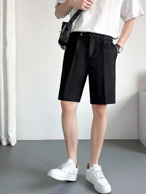 Black belted chino shorts with pleats and a relaxed fit.