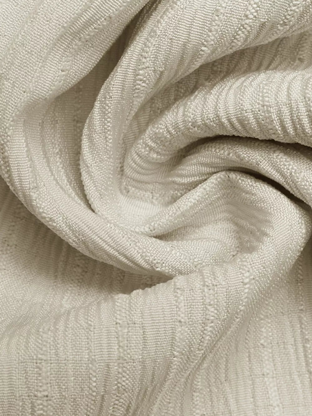 Textured ivory fabric with vertical ribbed pattern, close-up detail