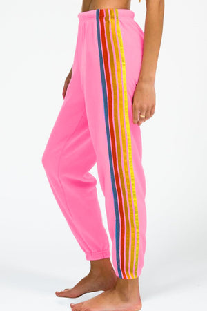 Pink track pants with rainbow stripe detail down the side