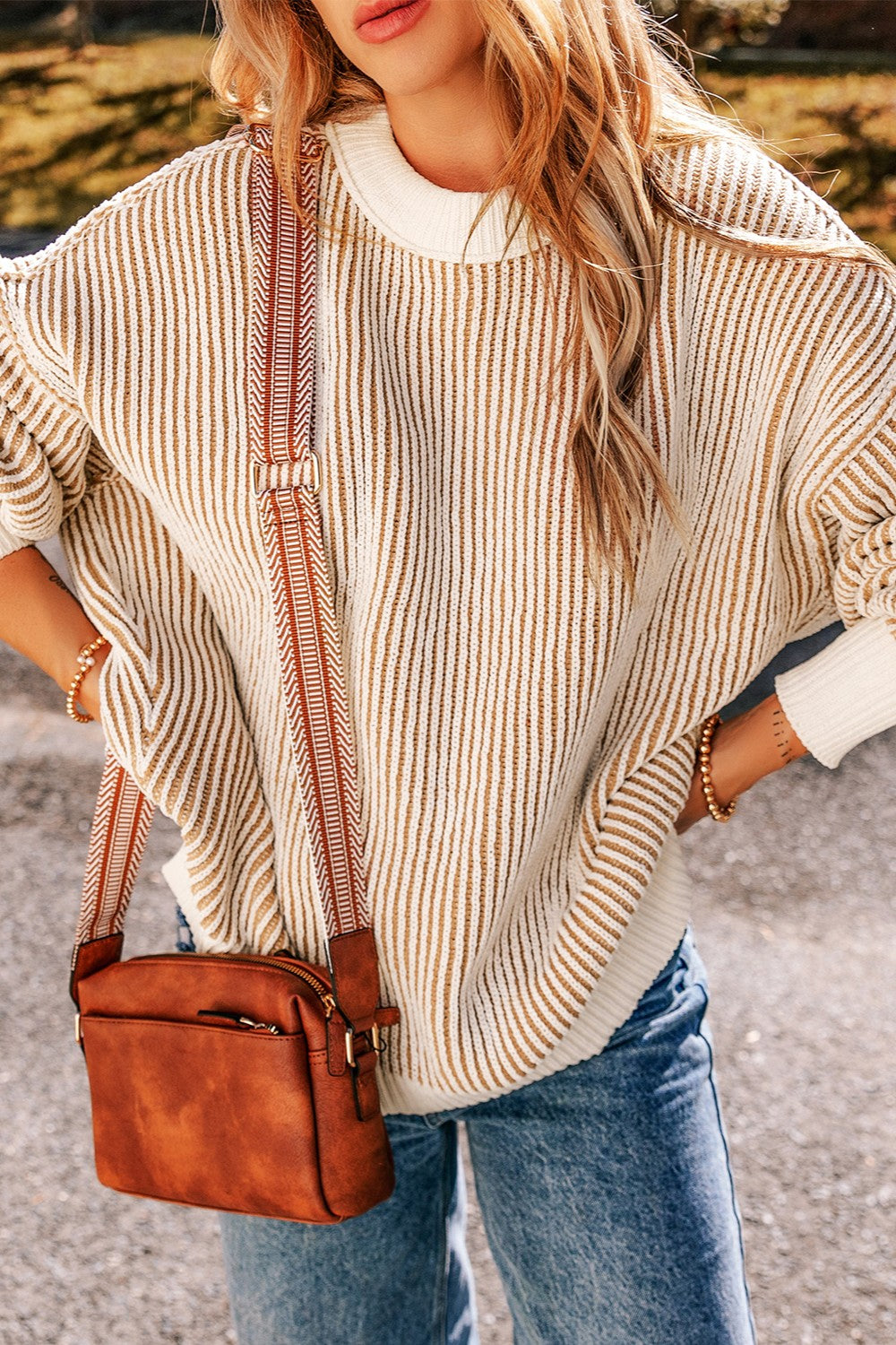 Vertical stripe drop-shoulder knit sweater in cream and camel with a crew neck.