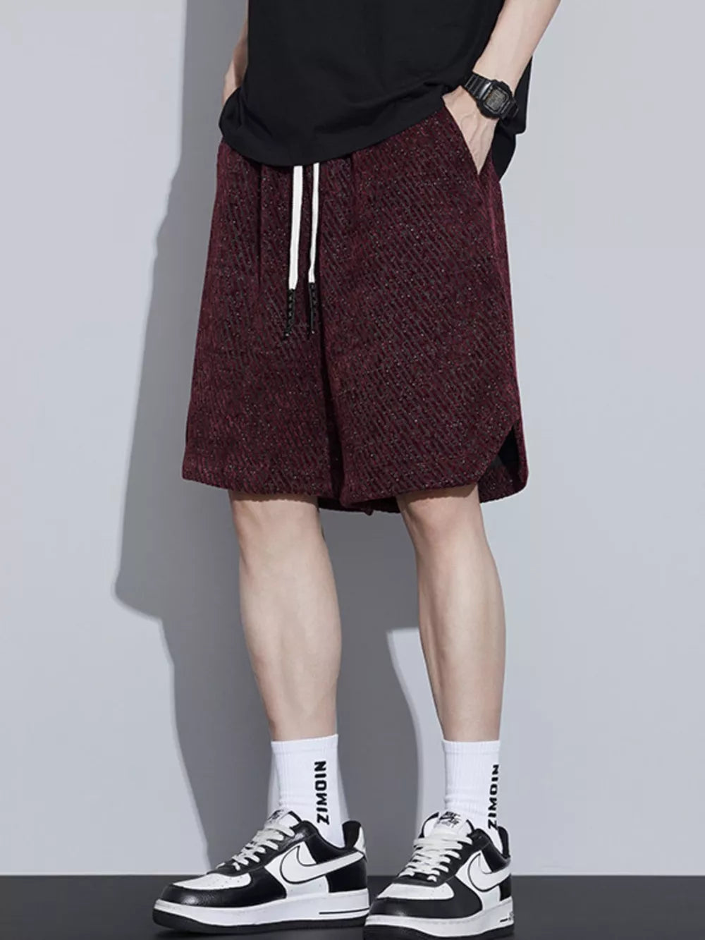 Burgundy textured boxer shorts with white drawstring and side pockets.