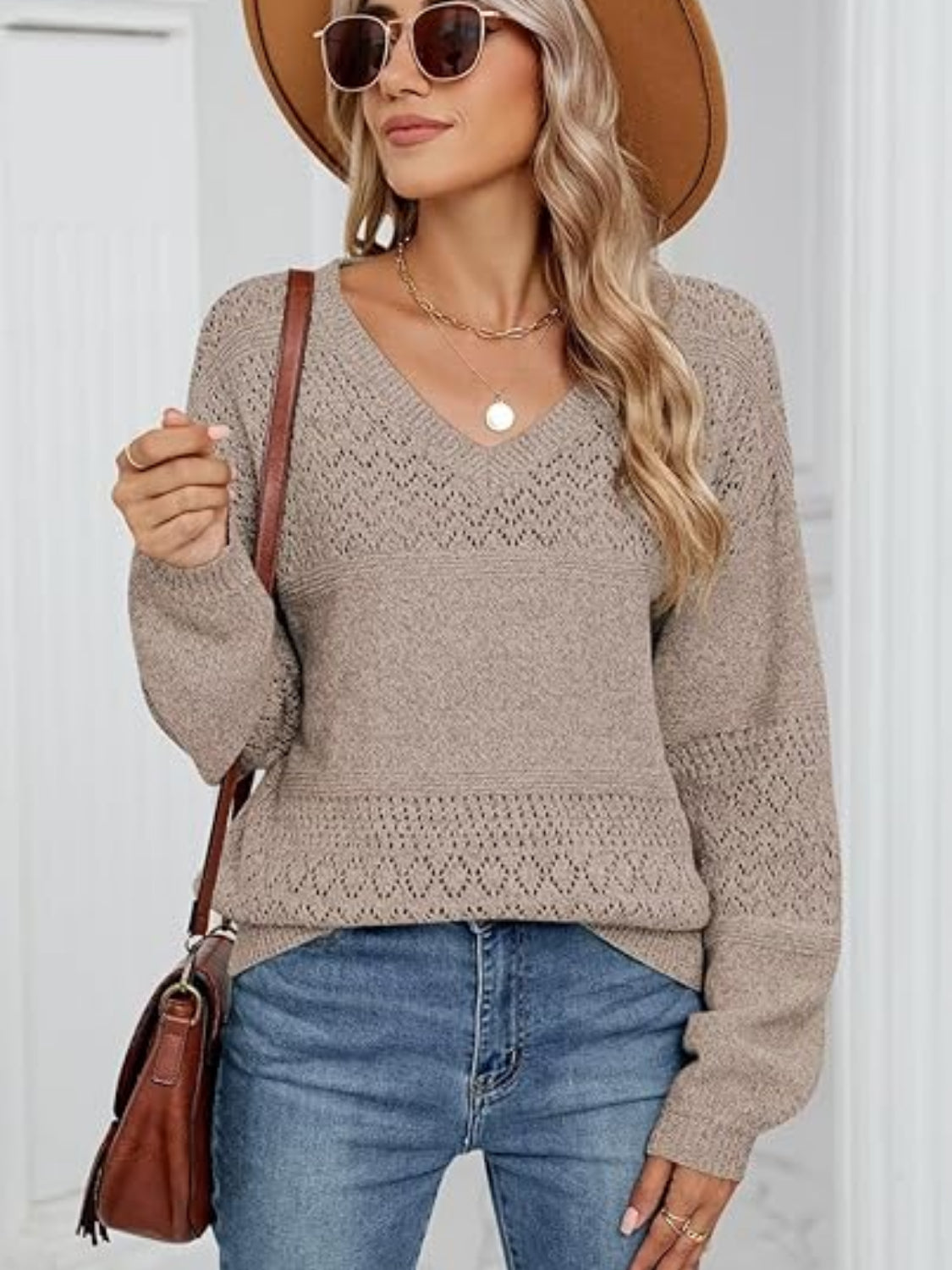 Tan eyelet stitch V-neck pullover sweater with textured yoke and sleeves.