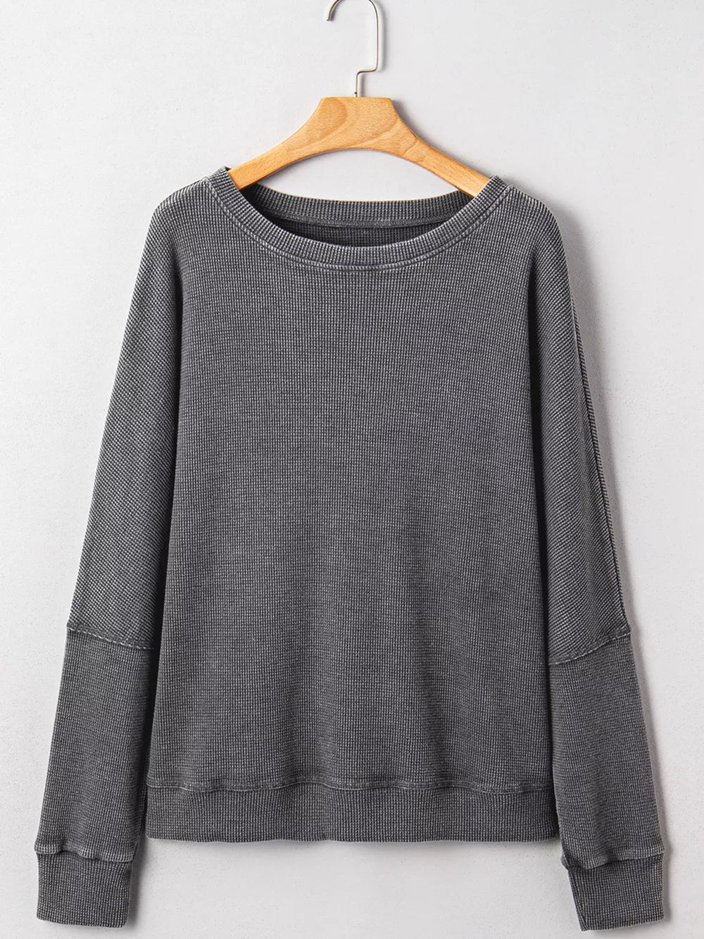 Dark gray waffle knit oversized sweatshirt with crew neck and long sleeves.