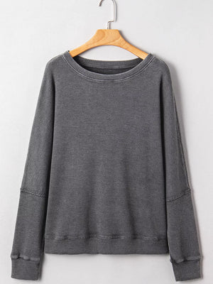 Dark gray waffle knit oversized sweatshirt with crew neck and long sleeves.