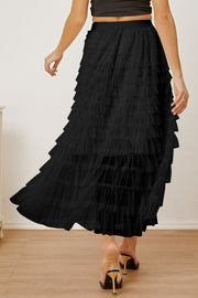 Black tiered tulle maxi skirt with a ruffled hem, shown from the back.
