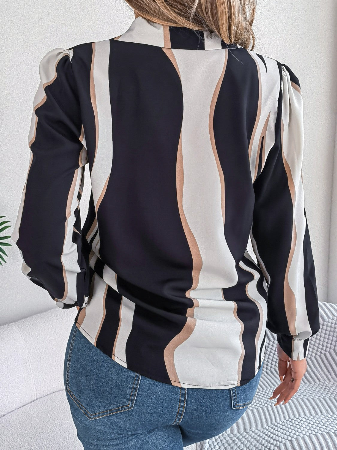 Wavy stripe collared blouse in black with white and tan wavy stripes, long sleeves, and a relaxed fit.