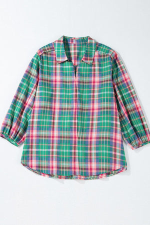 Voluminous plaid blouse with gathered sleeves and a V-neck.