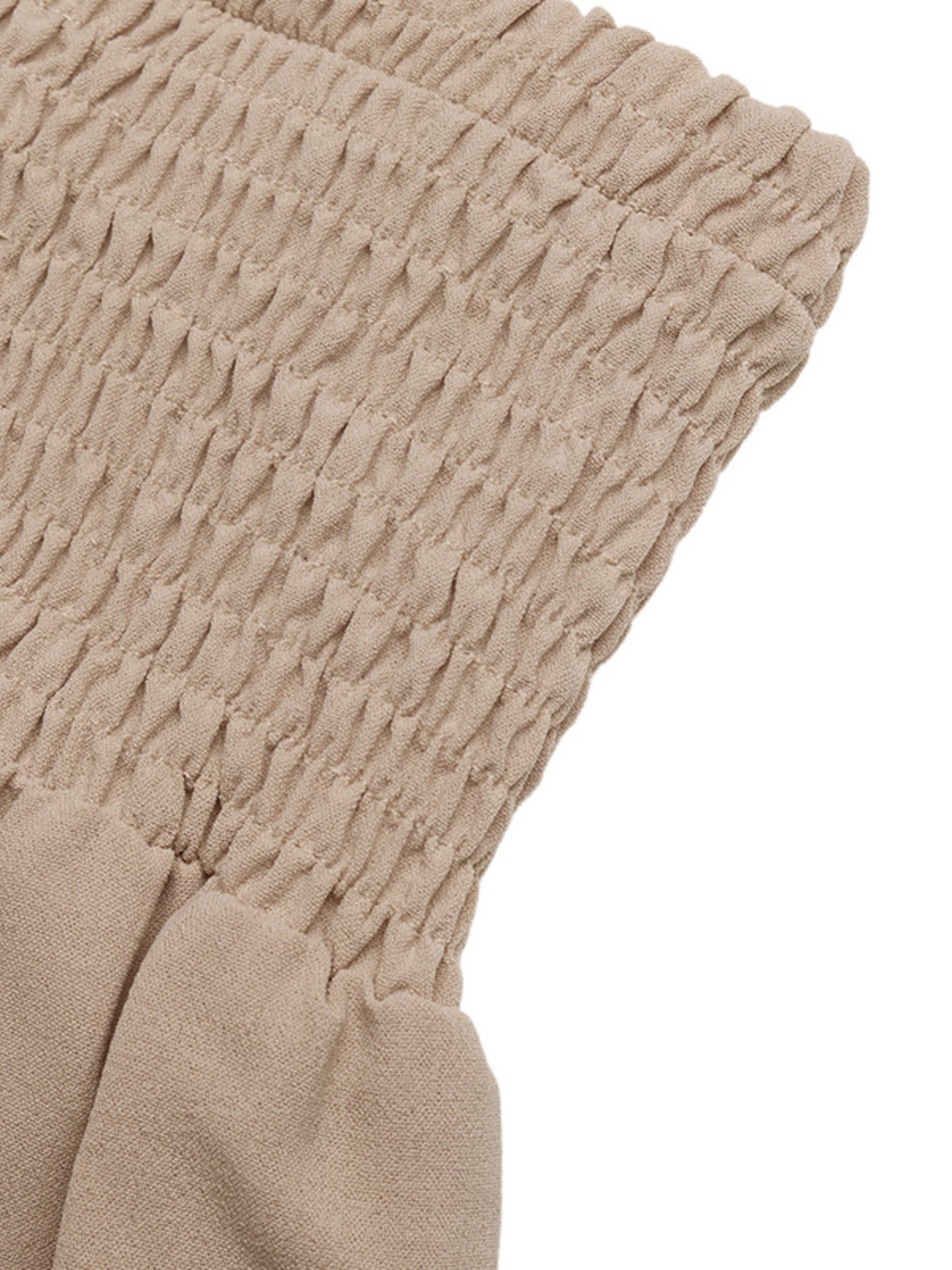 Smocked waist wide leg trousers in beige cotton, showing textured smocking detail.