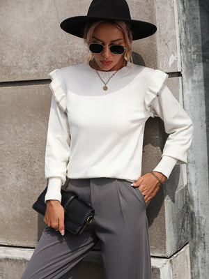 White crew neck sweater with contrast trim ruffle shoulders and ribbed cuffs.