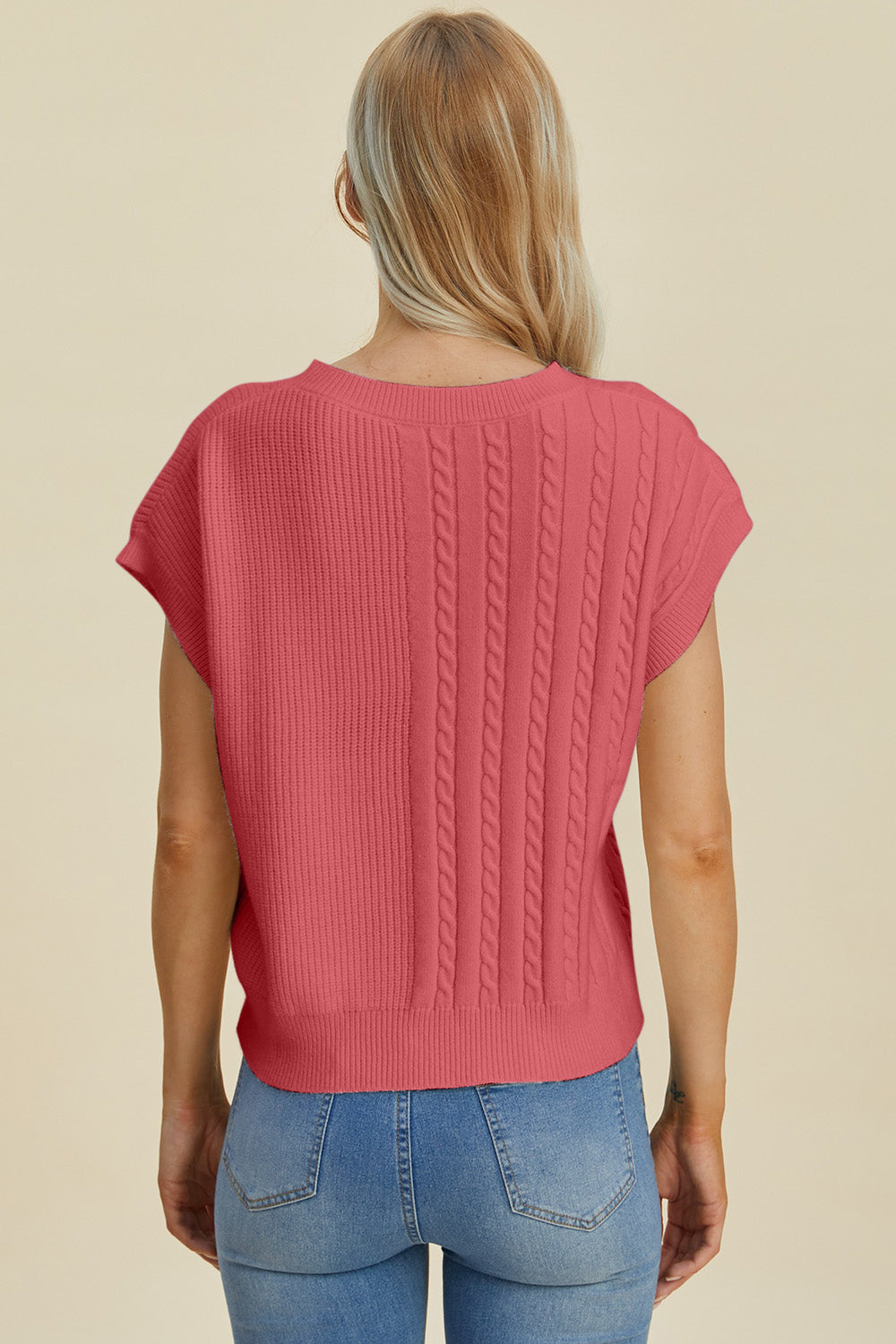 Cable knit cap sleeve pullover in strawberry with ribbed and cable knit panels.