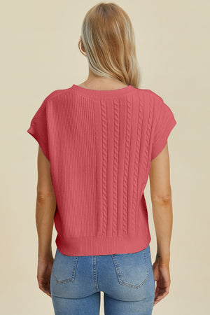 Cable knit cap sleeve pullover in strawberry with ribbed and cable knit panels.