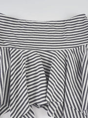 Asymmetrical hem mini skirt with black and white stripes and a ruffled detail.