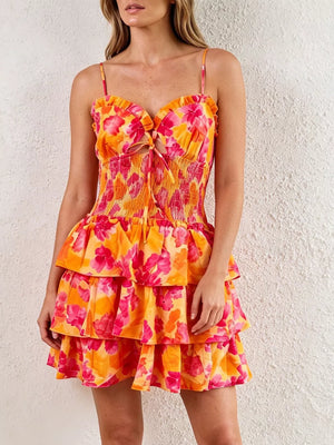 Floral cutout tiered mini dress with smocked waist and ruffled neckline.