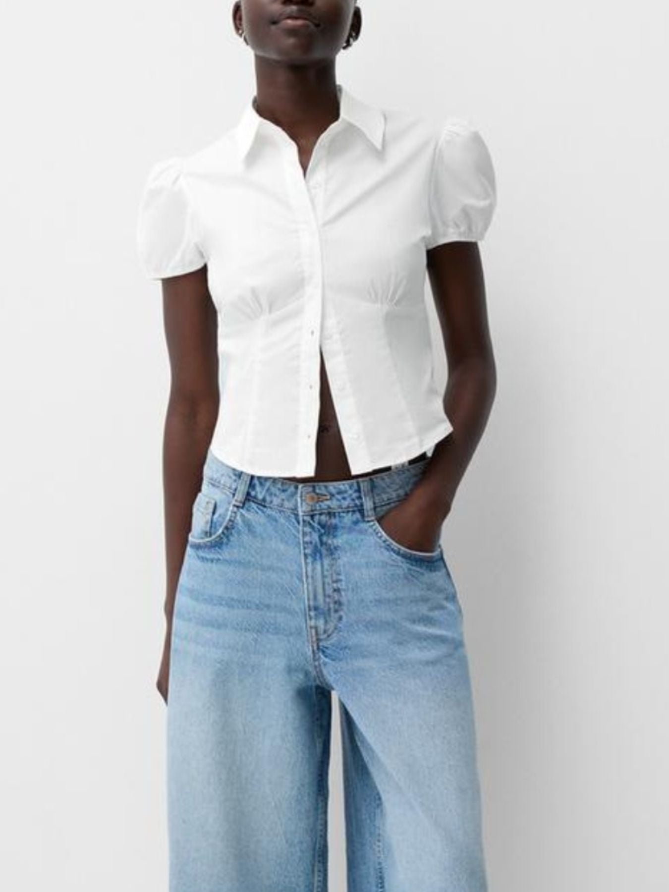 White maternity shirt with puff sleeves, gathered waist, and button-up front.