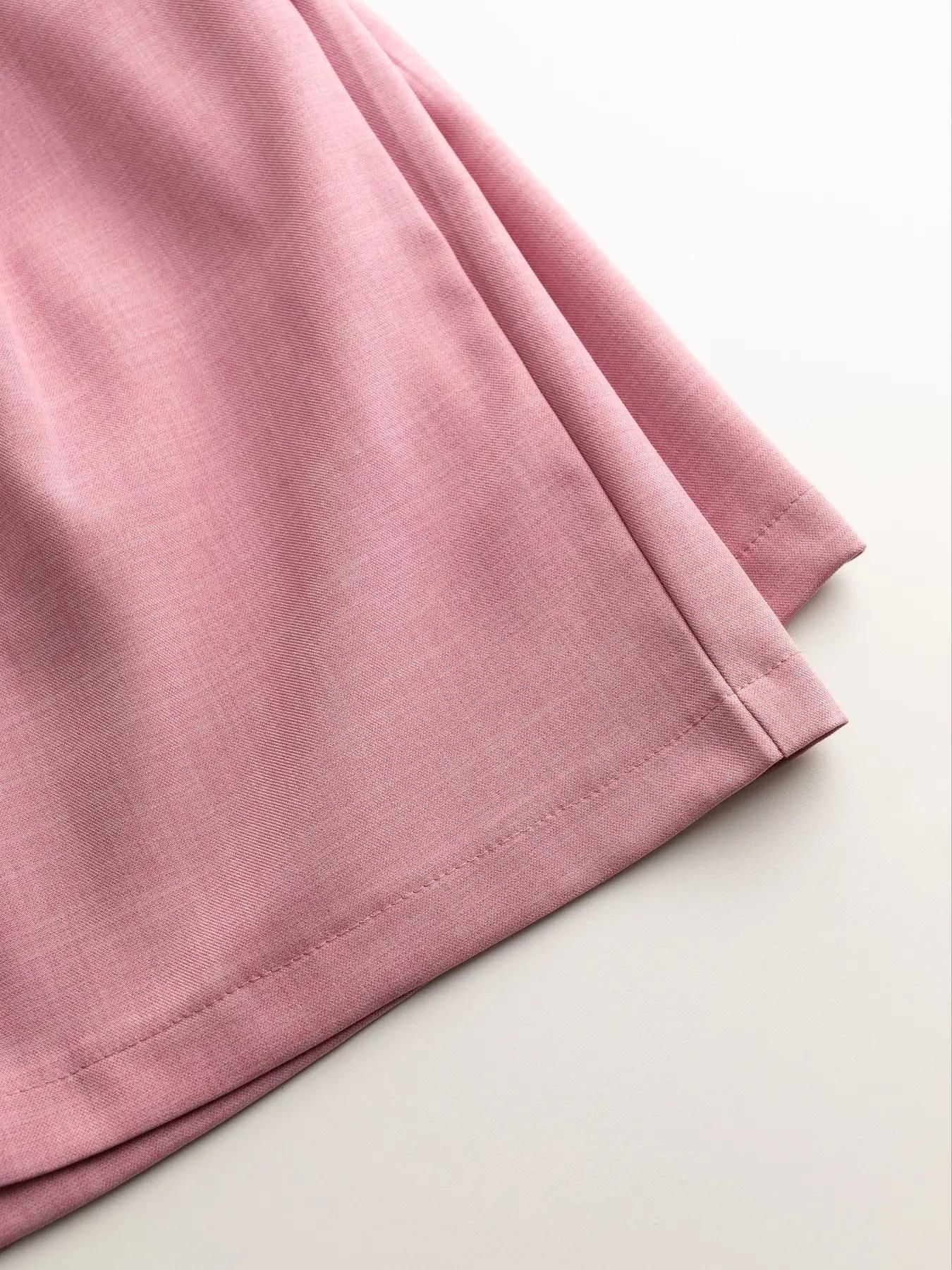 Pink relaxed blazer shorts set detail, showing fabric texture and hem stitching.