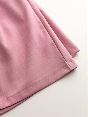 Pink relaxed blazer shorts set detail, showing fabric texture and hem stitching.