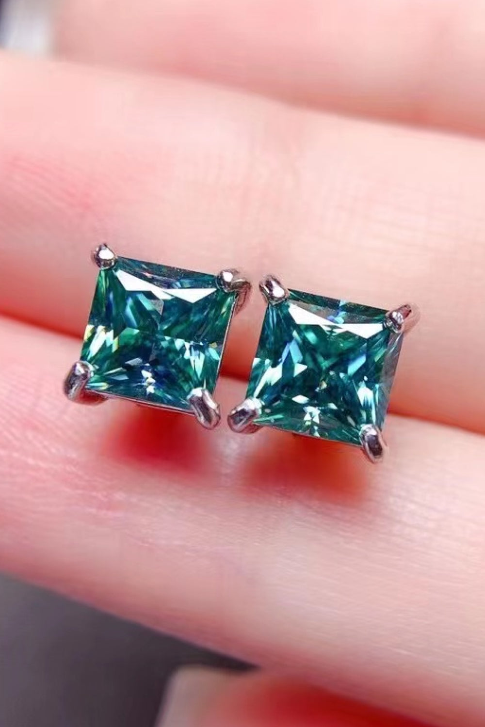 Emerald cut stud earrings in green with silver setting