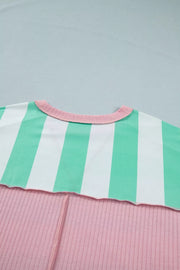 Oversized t-shirt with green and white stripes, pink ribbed bottom, and pink neckline.