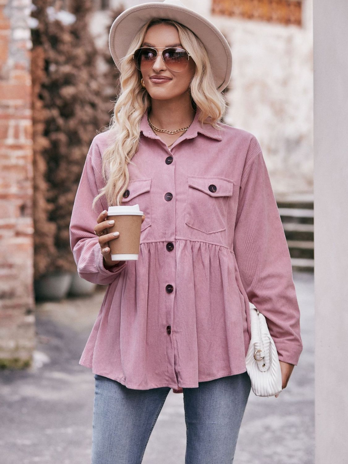 Pink corduroy peplum shirt jacket with buttoned pockets and a flared hem.
