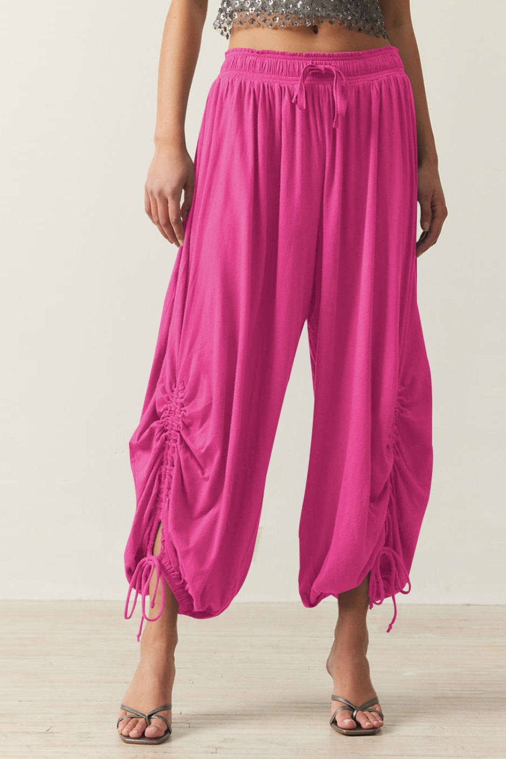 Hot Pink gathered ankle-tie balloon trousers with drawstring waist and ruched sides.