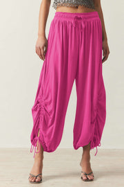 Hot Pink gathered ankle-tie balloon trousers with drawstring waist and ruched sides.
