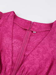 Vibrant cerise mini dress with deep V-neck, cutout detail, and floral jacquard pattern.