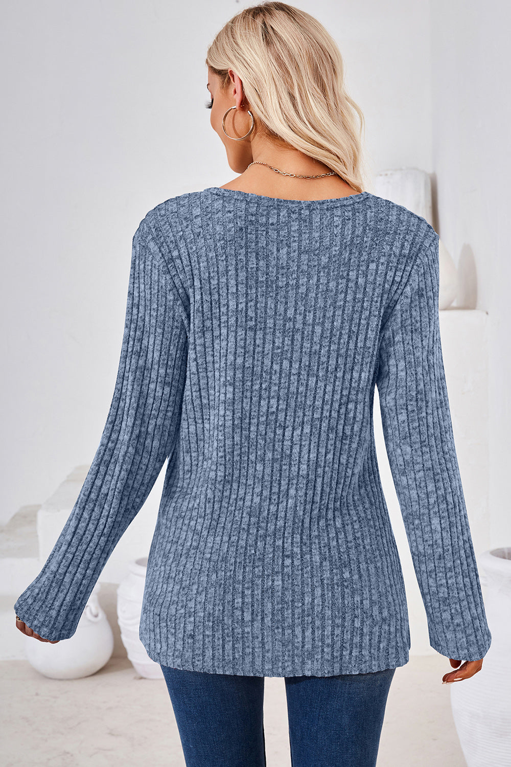 Dusty blue ribbed knit sweater with long sleeves and a crew neck.