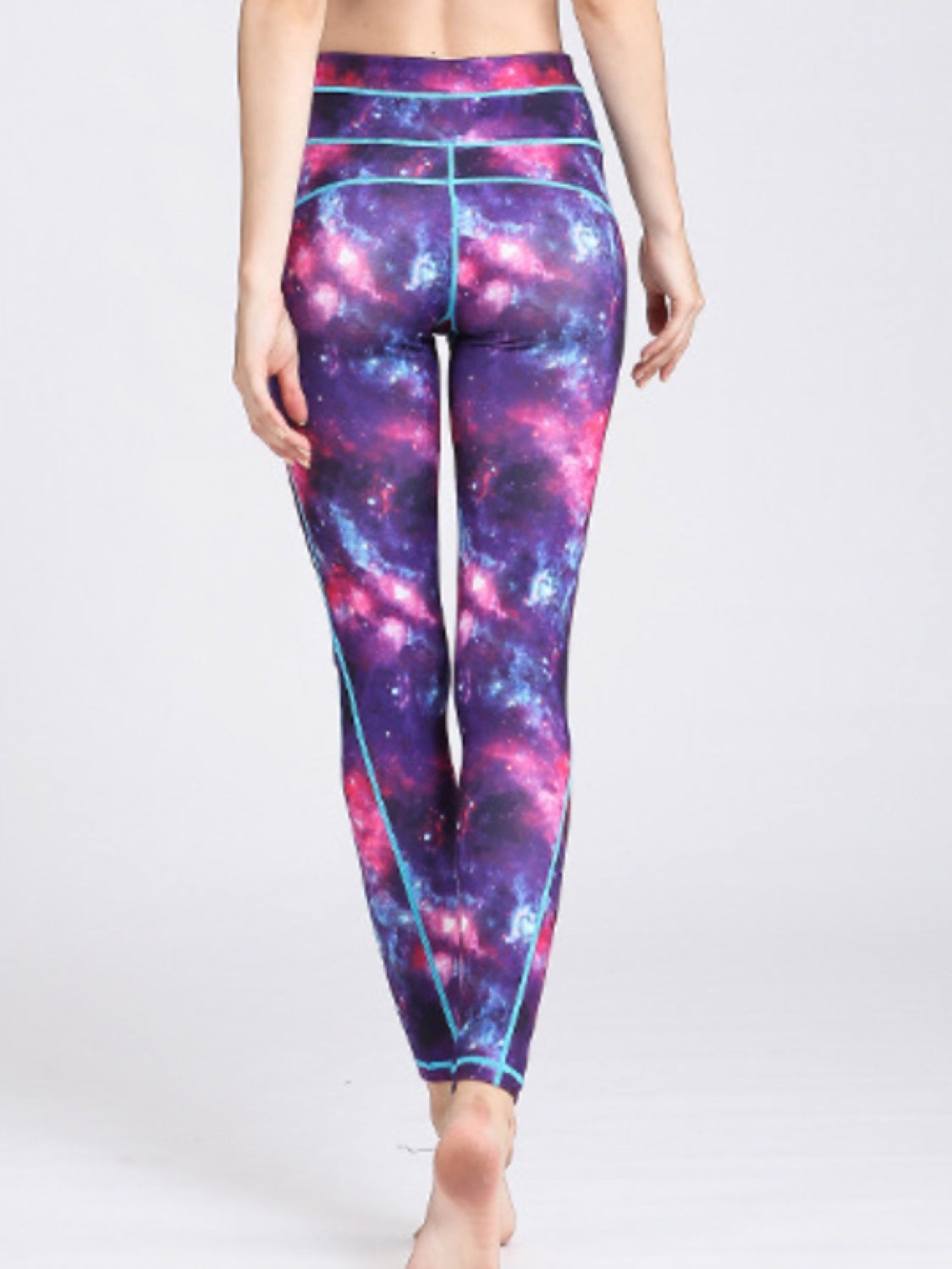 Cosmic print contour leggings in purple with turquoise piping and a high waist.