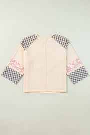 Patchwork heart raglan top in tan with plaid and floral print sleeves.