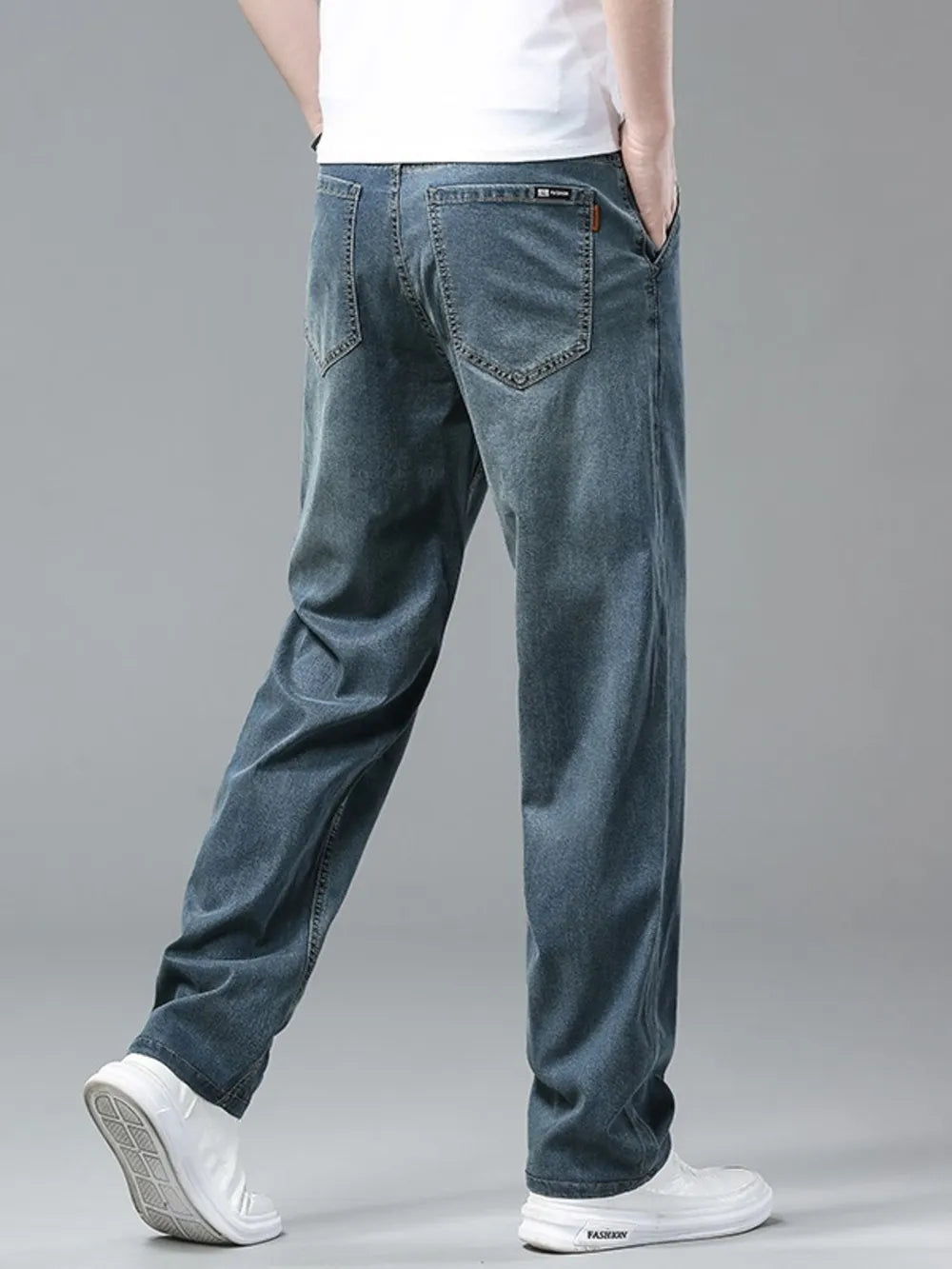 Men's relaxed fit denim sweatpants in light blue, with a comfortable casual style.