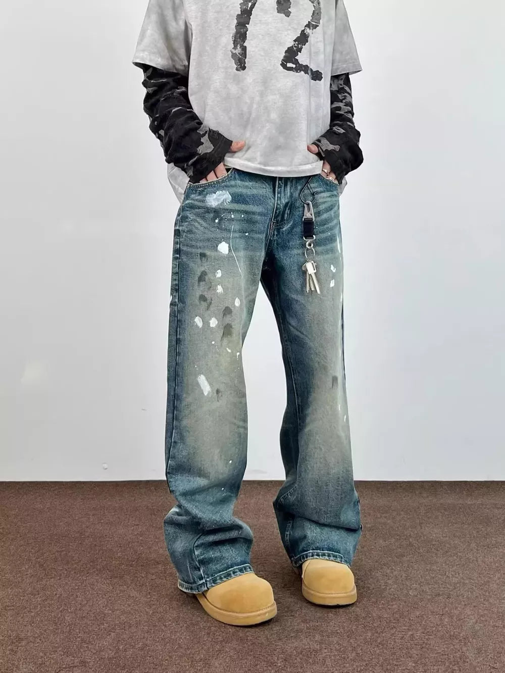 Blue 100% cotton wide leg jeans with paint splatters and distressed details.