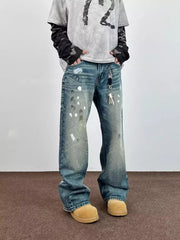 Blue 100% cotton wide leg jeans with paint splatters and distressed details.