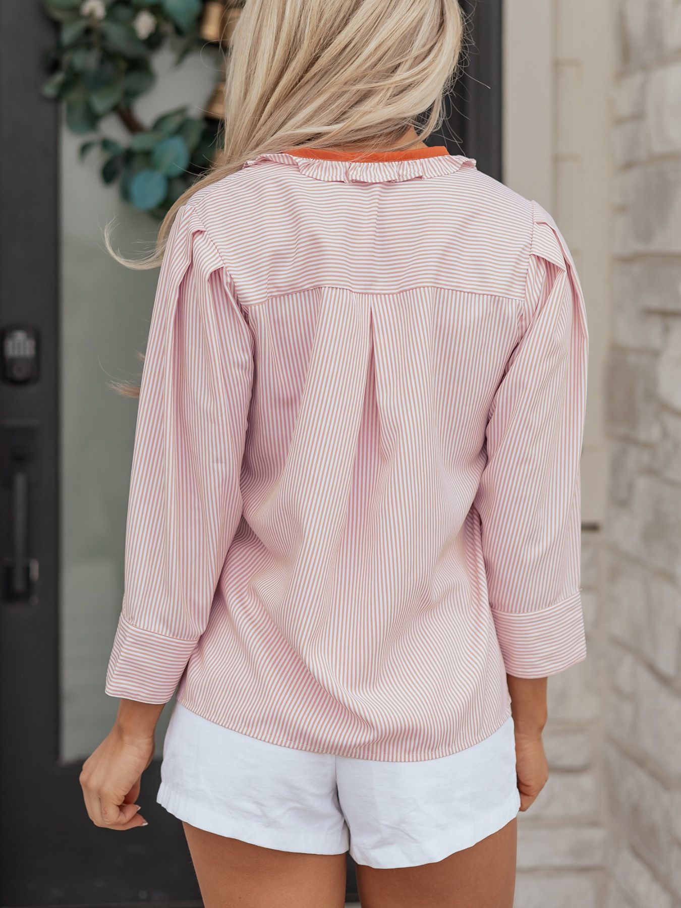 Pink striped maternity shirt with frilled collar and button-down detail.
