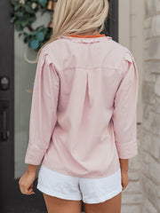 Pink striped maternity shirt with frilled collar and button-down detail.
