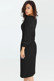 Black belted midi dress with pleated knit skirt and bishop sleeves.