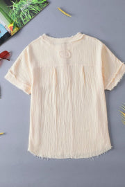 Beige textured gauze henley blouse with raw edges and button detail.