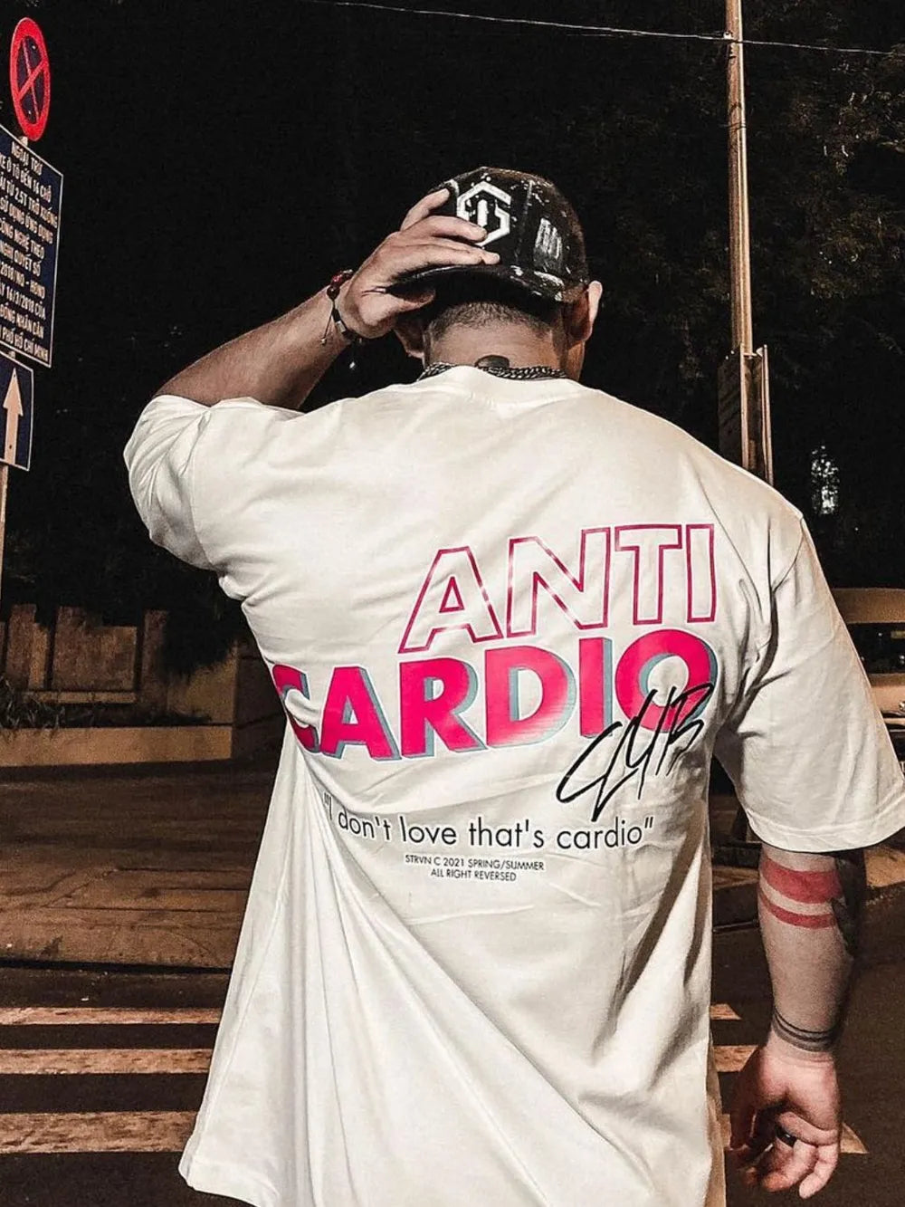 White graphic t-shirt with bold pink "ANTI CARDIO CLUB" text and a quote.