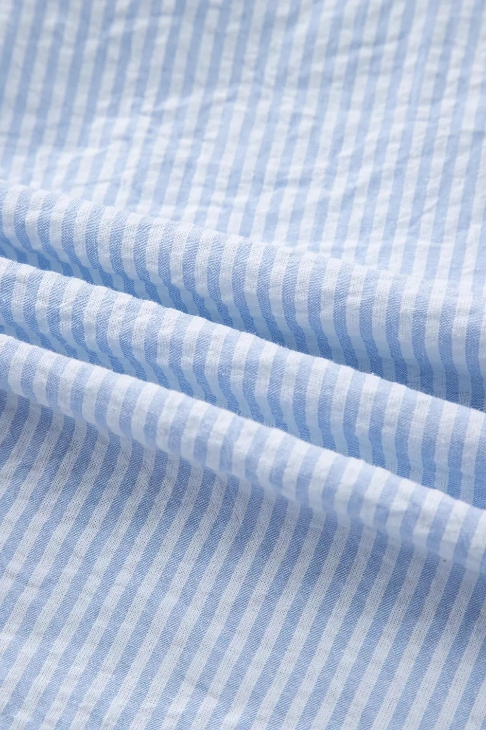 Blue and white striped cotton shirt fabric detail