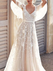 White lace flutter sleeve v-neck dress with floral embroidery and a satin belt.