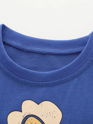 Blue cotton toddler t-shirt with whimsical bird and flower graphic detail.
