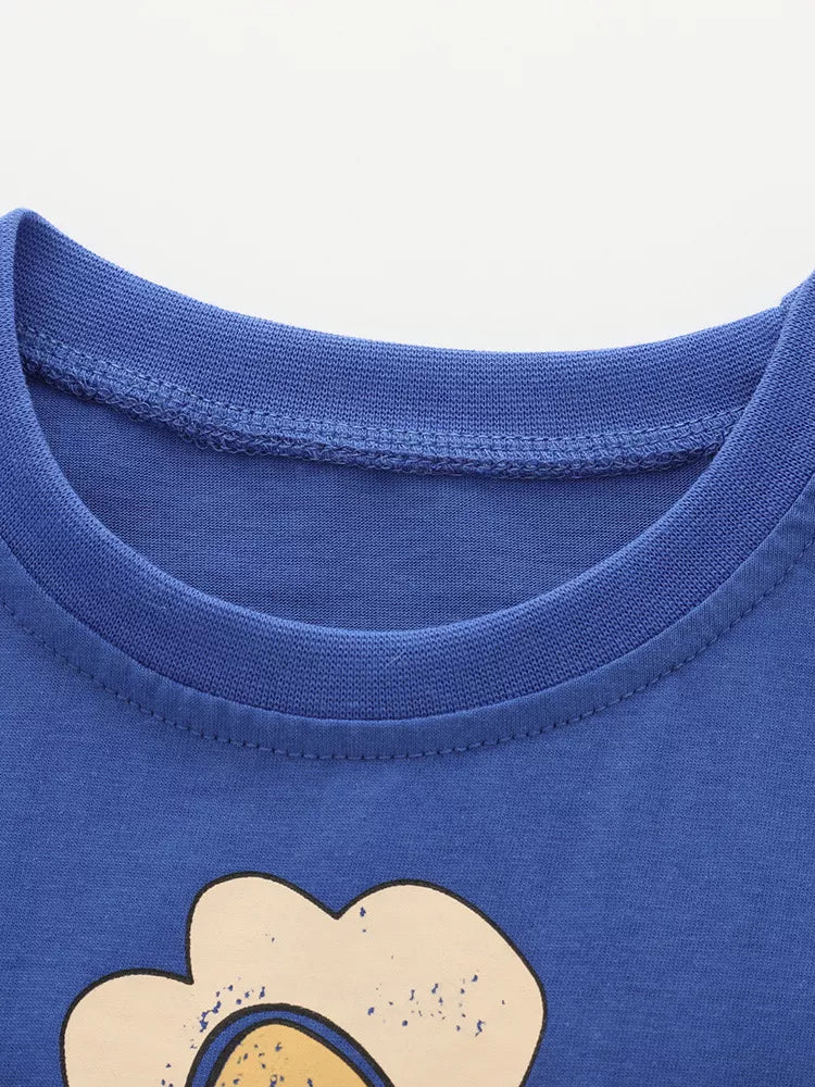 Blue cotton toddler t-shirt with whimsical bird and flower graphic detail.