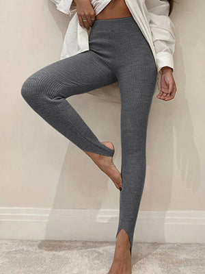 Charcoal ribbed knit stirrup leggings with a high waist and split hem.