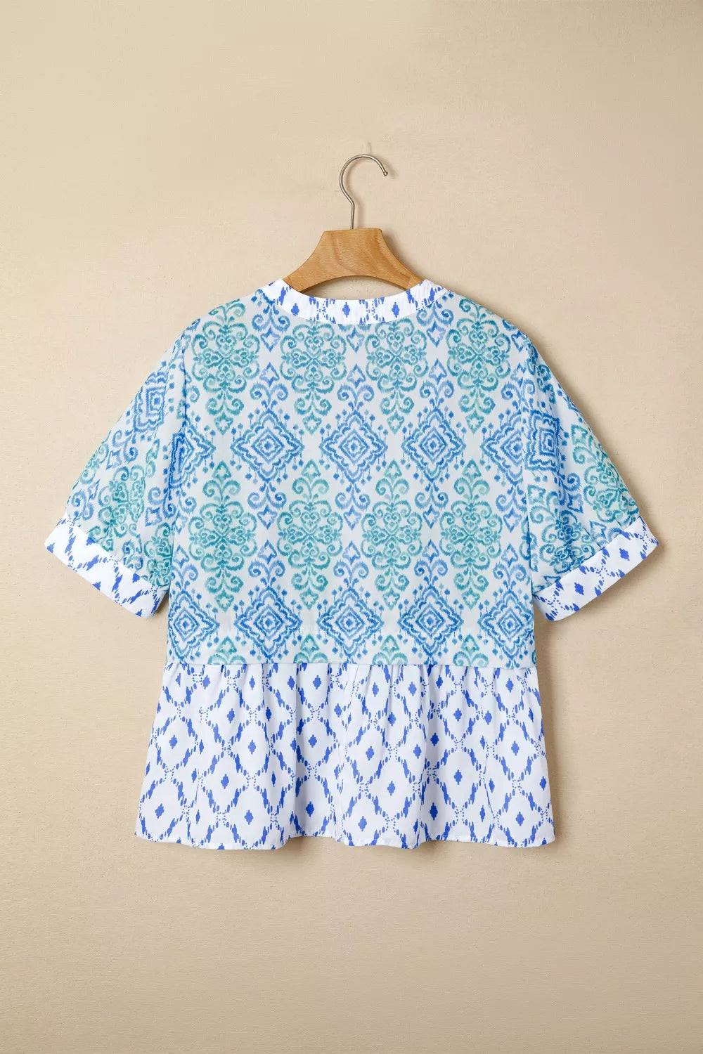 Patchwork babydoll maternity overshirt with puff sleeves in blue and green ikat print.