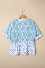 Patchwork babydoll maternity overshirt with puff sleeves in blue and green ikat print.