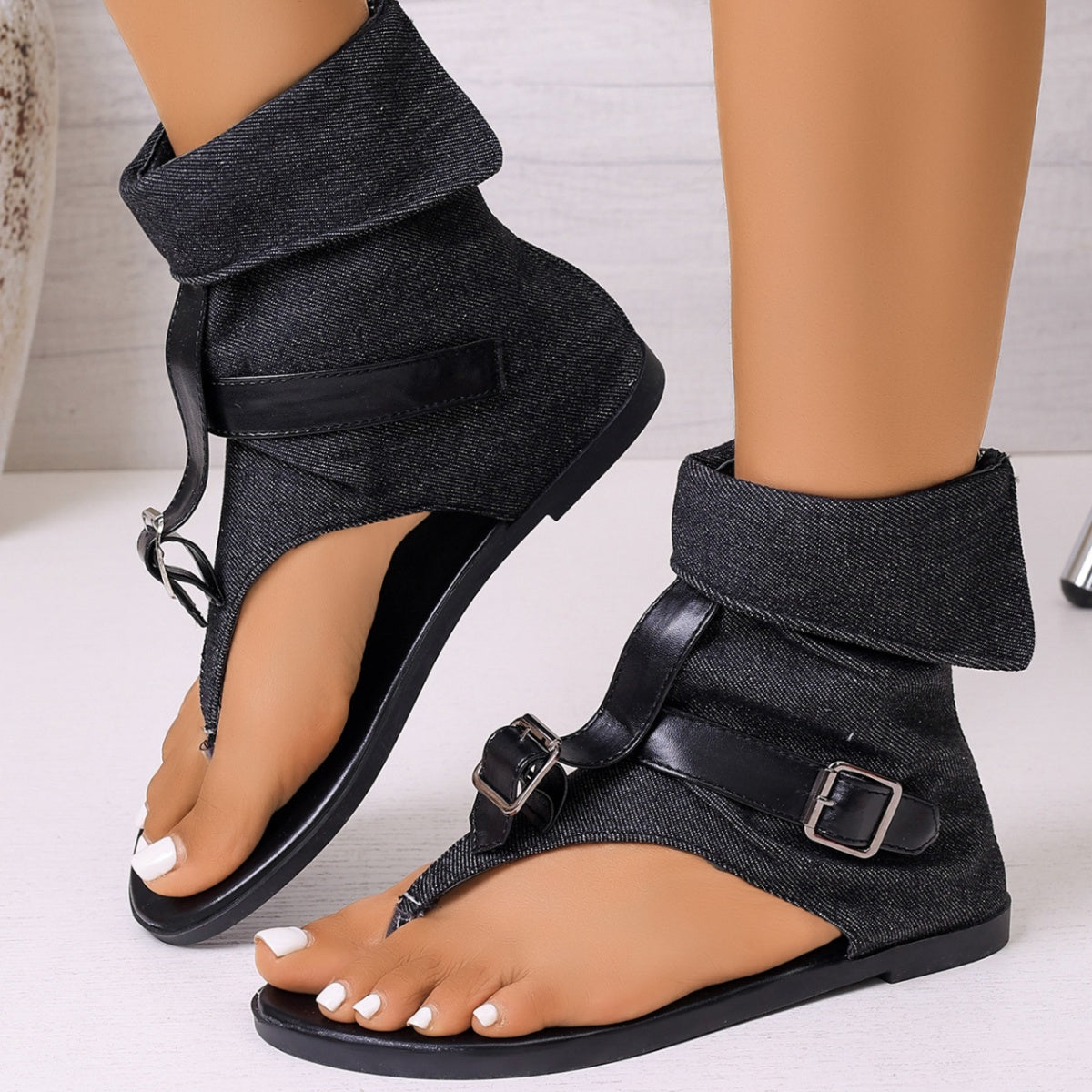Black denim gladiator sandals with buckle ankle straps and a folded cuff.