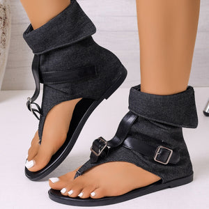 Black denim gladiator sandals with buckle ankle straps and a folded cuff.