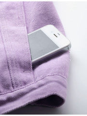 Lavender denim vest with frayed shoulders and a phone in the pocket